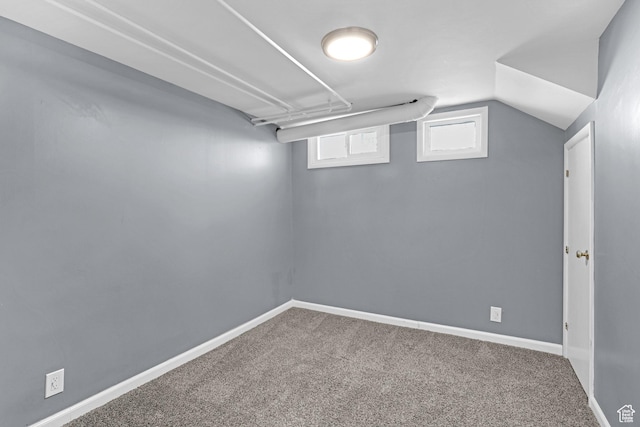 basement featuring carpet flooring and baseboards