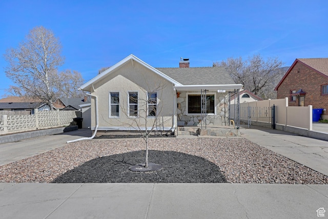 bungalow featuring fence, stucco siding, stone siding, and a chimney