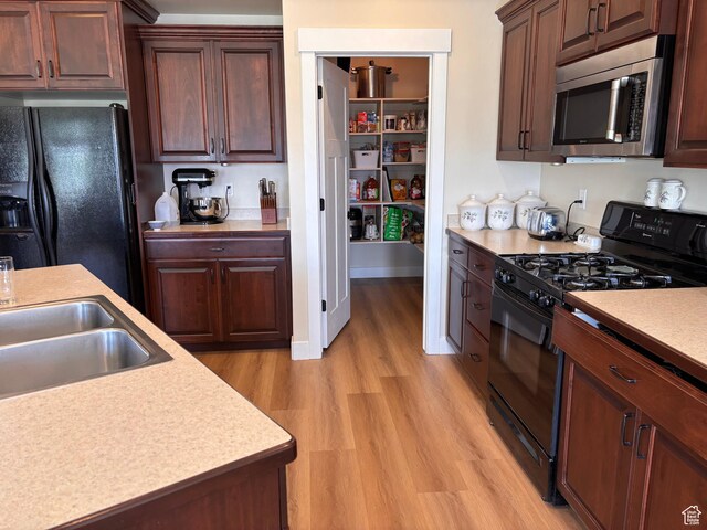 1234 S 1150 W, Payson, UT 84651 - kitchen featuring black appliances, light countertops, light wood finished floors, and a sink