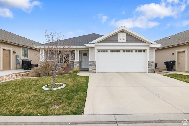 view of front of property with a front yard, driveway, stone siding, and an attached garage