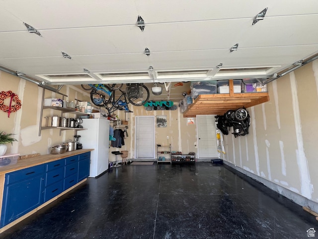 garage with freestanding refrigerator