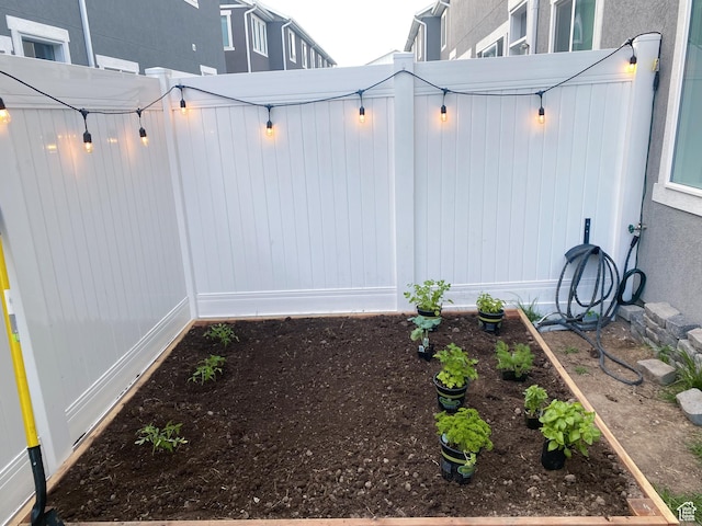 view of yard with fence and a vegetable garden