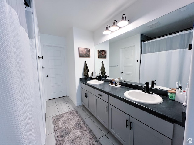 bathroom featuring a sink and double vanity