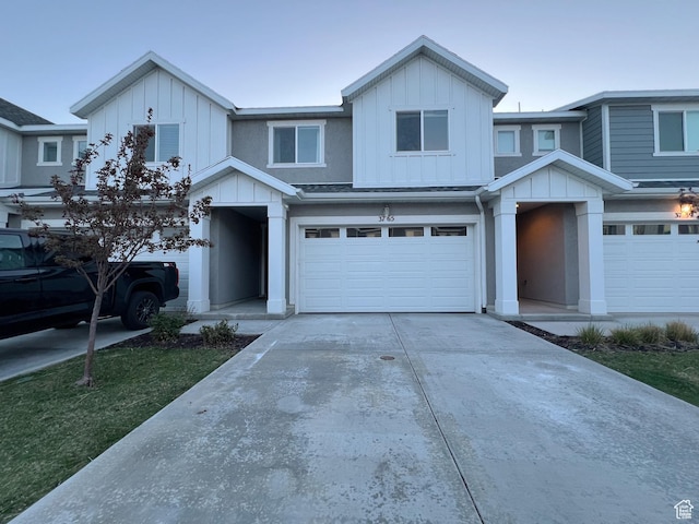 view of front facade featuring a garage, board and batten siding, and concrete driveway