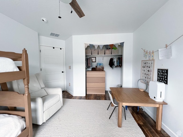 home office with visible vents, baseboards, a ceiling fan, and dark wood-style floors