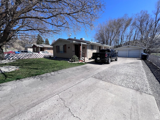 174 N 500 E, Logan, UT 84321 - view of front of property featuring an outdoor structure, a front lawn, brick siding, a garage, and fence
