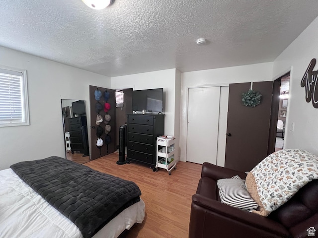 174 N 500 E, Logan, UT 84321 - bedroom with a textured ceiling and wood finished floors