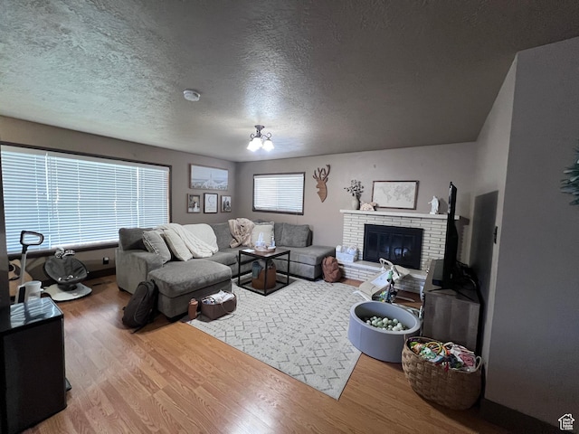 174 N 500 E, Logan, UT 84321 - living room featuring a textured ceiling, wood finished floors, and a fireplace