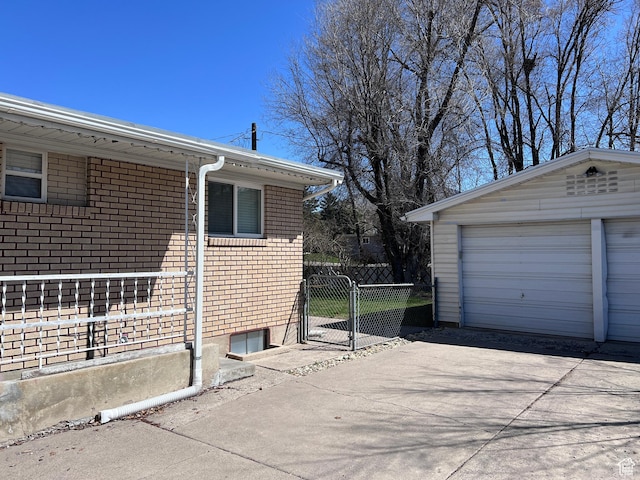 174 N 500 E, Logan, UT 84321 - view of side of property featuring a gate, fence, an outdoor structure, and brick siding