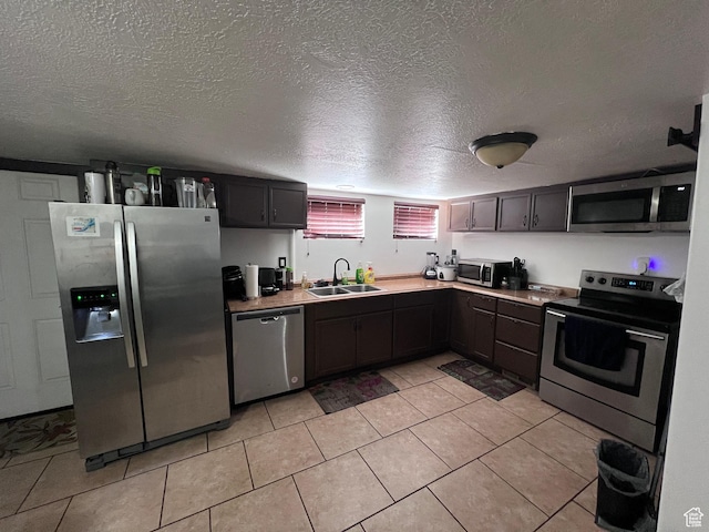 174 N 500 E, Logan, UT 84321 - kitchen with a sink, light tile patterned floors, appliances with stainless steel finishes, and a textured ceiling