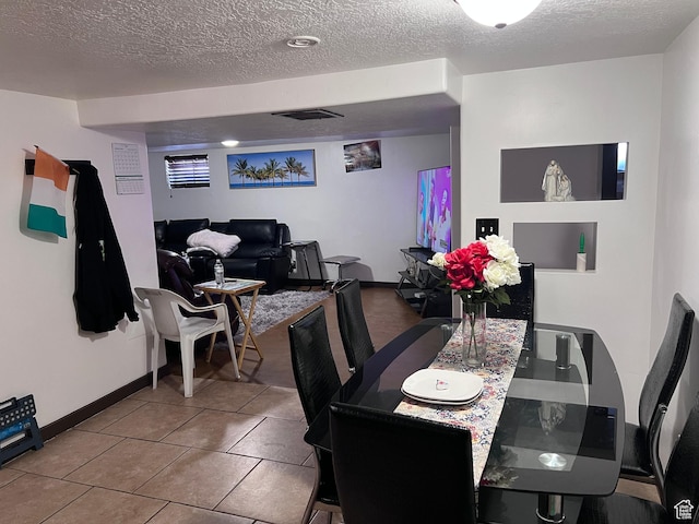 174 N 500 E, Logan, UT 84321 - tiled dining space with visible vents, baseboards, and a textured ceiling