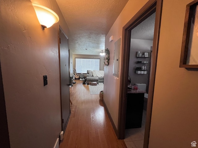 174 N 500 E, Logan, UT 84321 - corridor with a textured ceiling, light wood finished floors, and baseboards