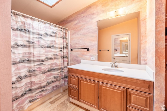 69 E Coronado Ln, Moab, UT 84532 - bathroom featuring a shower with shower curtain, lofted ceiling, vanity, and wood finished floors