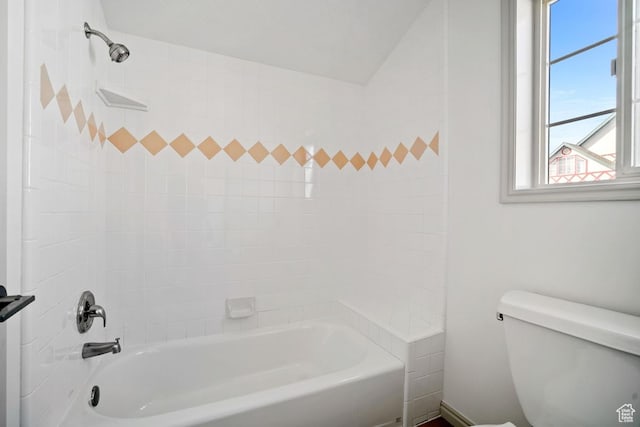 bathroom with toilet, washtub / shower combination, and plenty of natural light