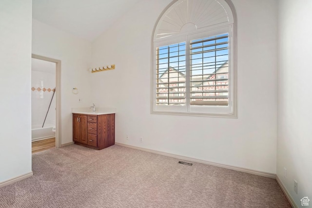 unfurnished bedroom featuring visible vents, light carpet, and baseboards
