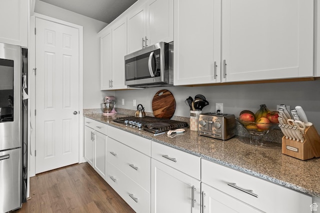 11534 S Rk Cv, South Jordan, UT 84095 - kitchen featuring stainless steel appliances, white cabinetry, light stone countertops, and dark wood-style flooring