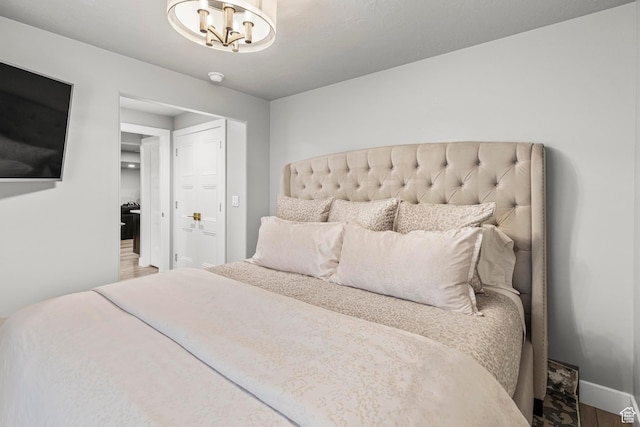 11534 S Rk Cv, South Jordan, UT 84095 - bedroom featuring wood finished floors, a chandelier, and baseboards