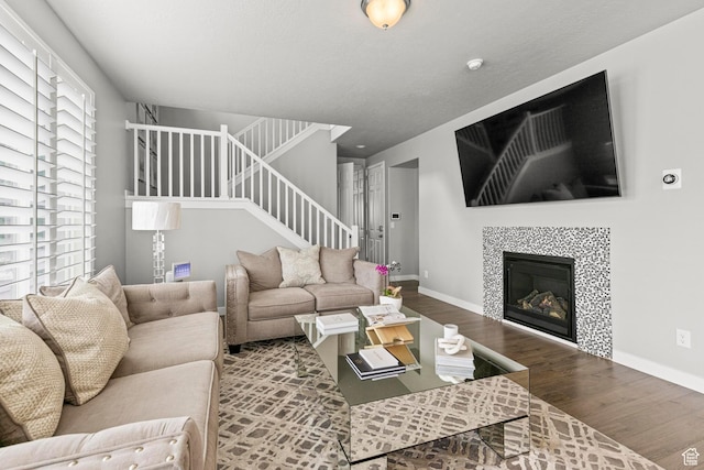 11534 S Rk Cv, South Jordan, UT 84095 - living area featuring wood finished floors, stairway, baseboards, and a fireplace