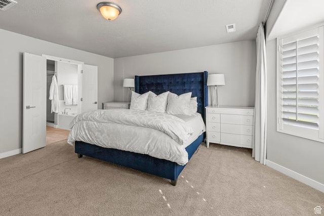 11534 S Rk Cv, South Jordan, UT 84095 - carpeted bedroom featuring baseboards, a textured ceiling, and connected bathroom