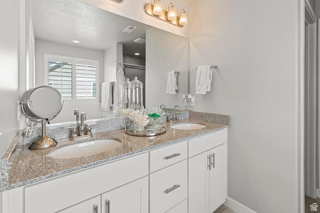 11534 S Rk Cv, South Jordan, UT 84095 - bathroom featuring double vanity and a textured ceiling