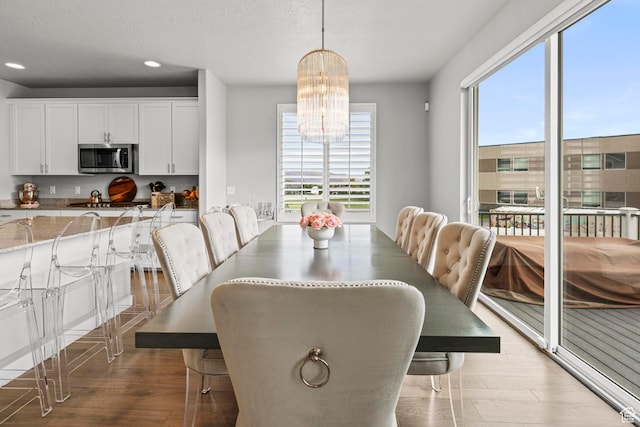 11534 S Rk Cv, South Jordan, UT 84095 - dining area featuring plenty of natural light, recessed lighting, a chandelier, and light wood finished floors