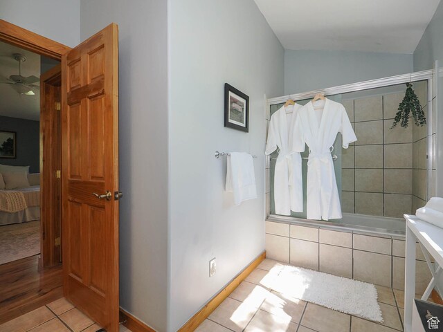 ensuite bathroom with ensuite bathroom, a ceiling fan, tile patterned flooring, and vaulted ceiling
