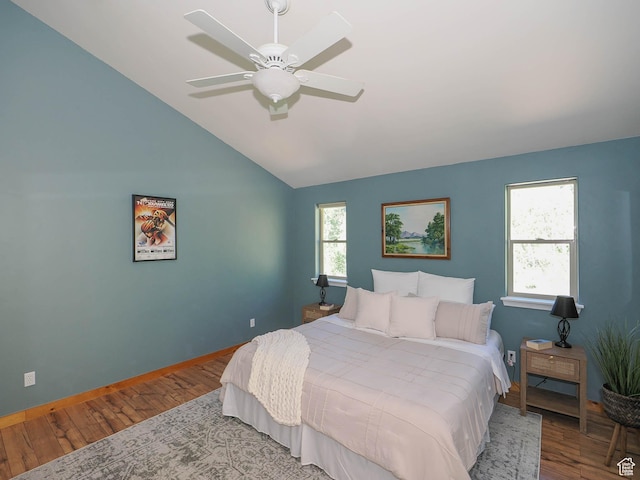 bedroom featuring lofted ceiling, ceiling fan, baseboards, and wood finished floors