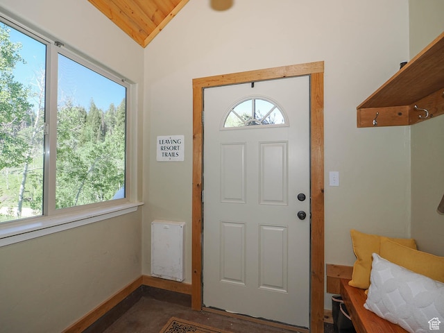 entryway with baseboards and lofted ceiling