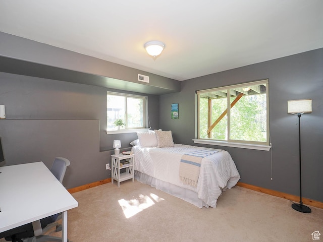 carpeted bedroom featuring visible vents and baseboards