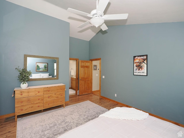 bedroom featuring wood finished floors, ceiling fan, baseboards, and vaulted ceiling