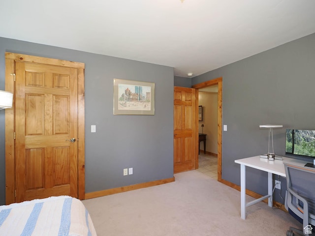 bedroom featuring baseboards and light colored carpet