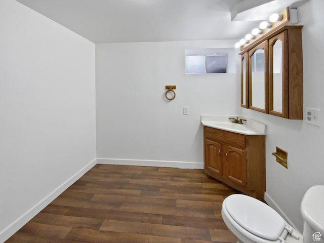 4445 S 4560 W, West Valley City, UT 84120 - half bathroom with toilet, wood finished floors, vanity, and baseboards