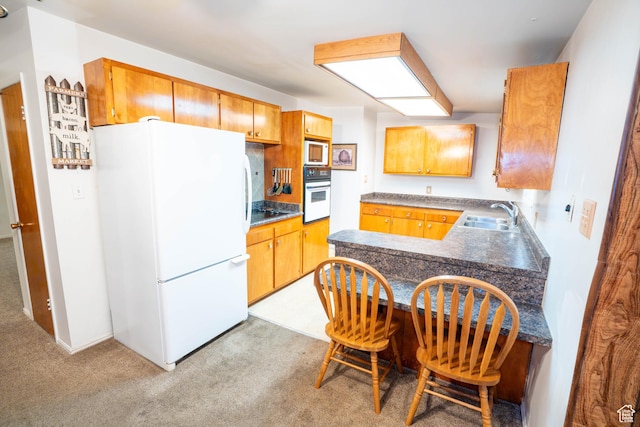 1915 W 13400 S, Riverton, UT 84065 - kitchen featuring white appliances, a sink, light colored carpet, a peninsula, and brown cabinetry