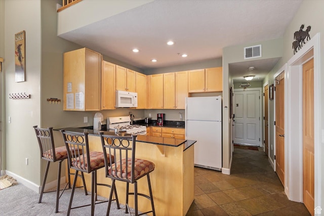 6749 N 2200 W Unit B302, Park City, UT 84098 - kitchen with visible vents, light brown cabinets, dark countertops, white appliances, and a peninsula