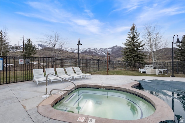 6749 N 2200 W Unit B302, Park City, UT 84098 - view of swimming pool with a mountain view, fence, a patio, and a hot tub