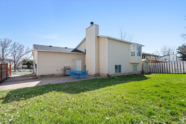 1107 E 2450 N, Layton, UT 84040 - back of property featuring a patio area, a yard, fence, and a chimney