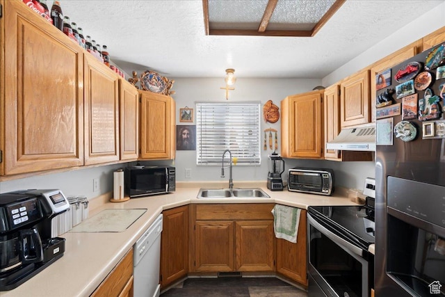 1107 E 2450 N, Layton, UT 84040 - kitchen featuring a textured ceiling, appliances with stainless steel finishes, under cabinet range hood, light countertops, and a sink