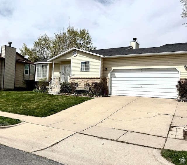 1107 E 2450 N, Layton, UT 84040 - view of front of property featuring concrete driveway, a chimney, a front lawn, an attached garage, and brick siding