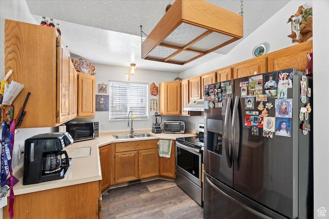 1107 E 2450 N, Layton, UT 84040 - kitchen featuring a textured ceiling, under cabinet range hood, wood finished floors, a sink, and stainless steel appliances