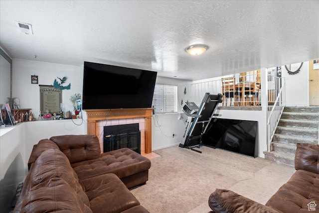 1107 E 2450 N, Layton, UT 84040 - carpeted living area with visible vents, stairs, a tile fireplace, and a textured ceiling