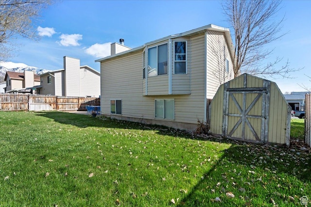 1107 E 2450 N, Layton, UT 84040 - back of property with an outdoor structure, fence, a yard, and a storage unit