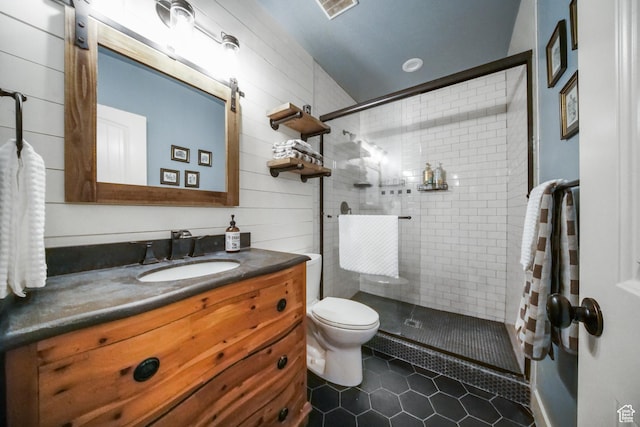 bathroom with a shower stall, tile patterned floors, vanity, and toilet