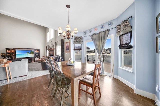 dining room with a chandelier, baseboards, dark wood-style floors, and a wealth of natural light
