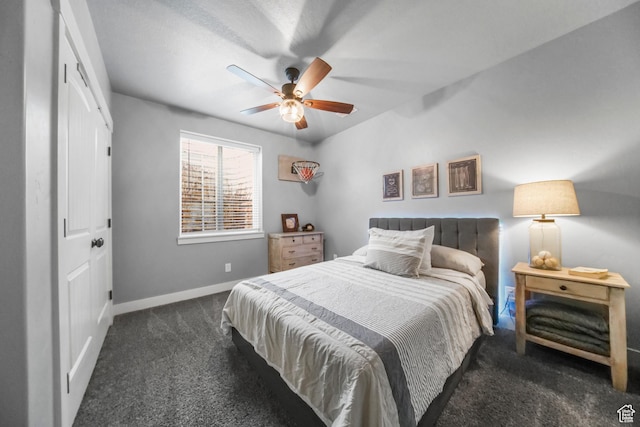 carpeted bedroom with ceiling fan and baseboards