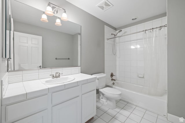 bathroom featuring visible vents, toilet, shower / bath combo with shower curtain, vanity, and tile patterned floors