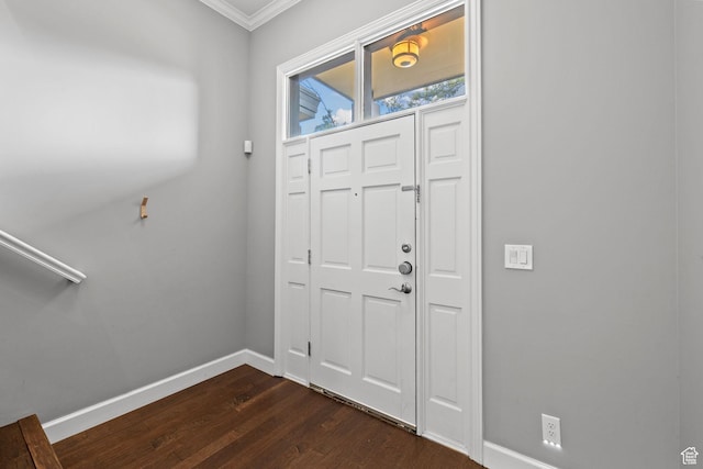 foyer with baseboards, ornamental molding, and dark wood finished floors