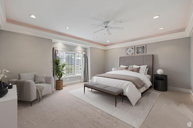 bedroom featuring a raised ceiling, light carpet, baseboards, and ornamental molding