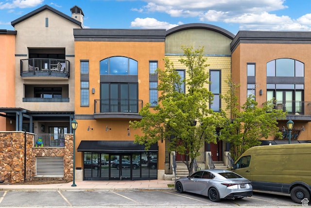 view of property featuring uncovered parking