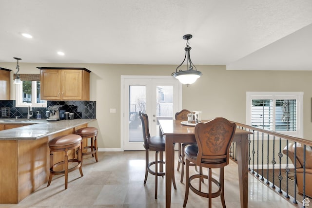 dining area with baseboards and recessed lighting