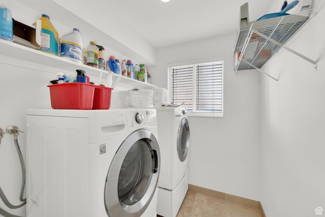 laundry area featuring laundry area, separate washer and dryer, and baseboards